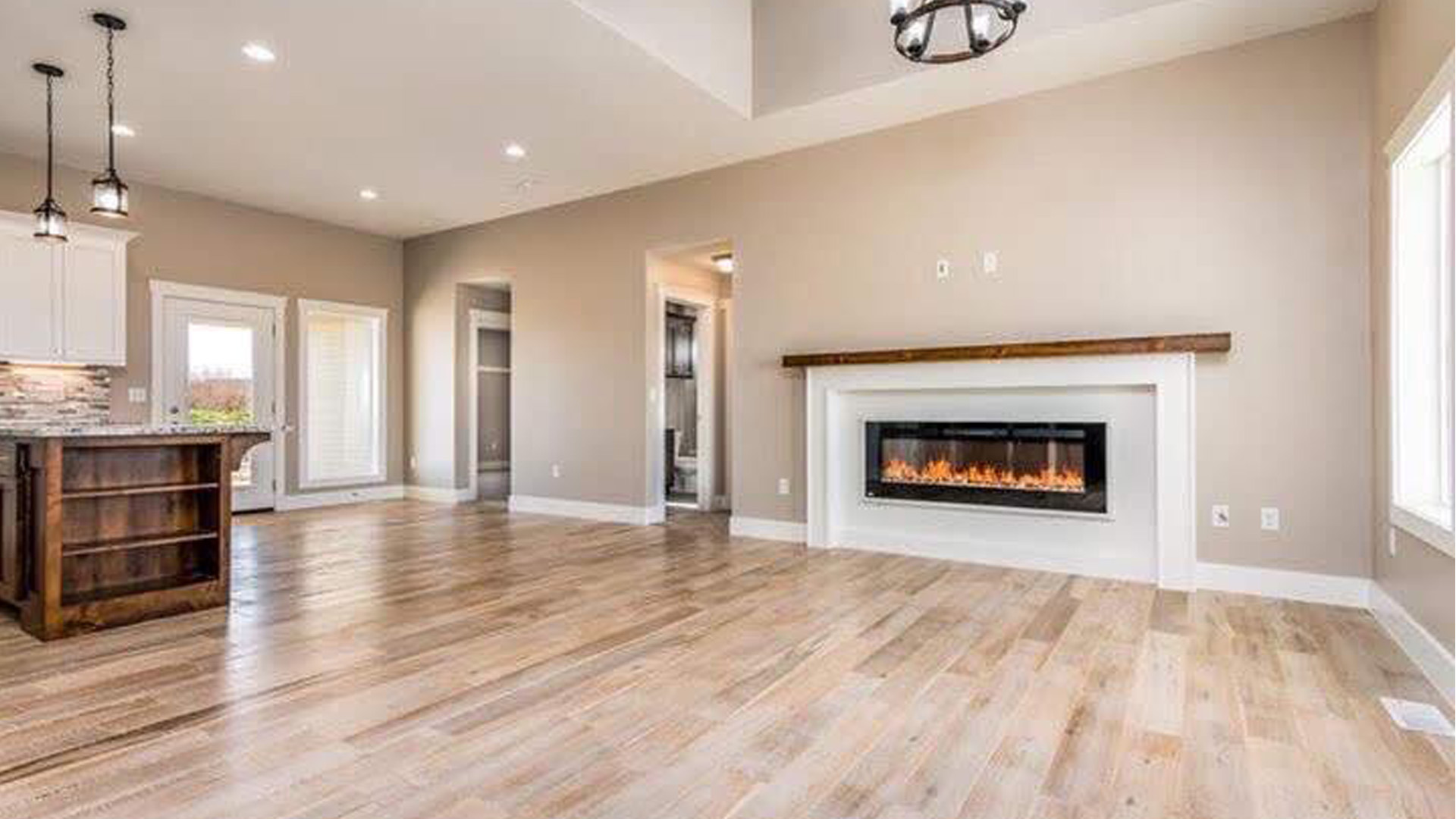 Bright living room with linear fireplace in a Spring Creek home